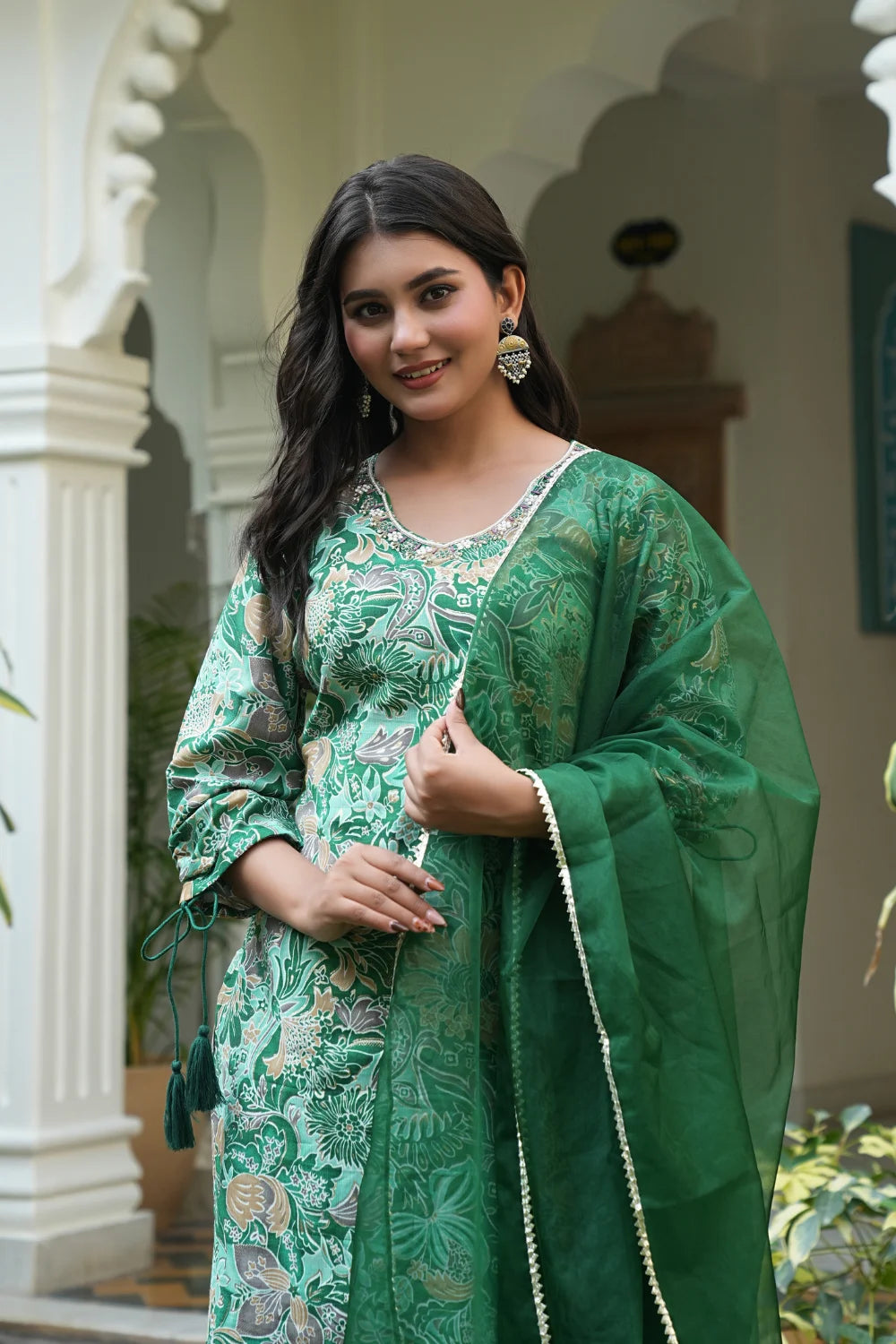 Close‑up of intricate hand embroidery on green kurti fabric